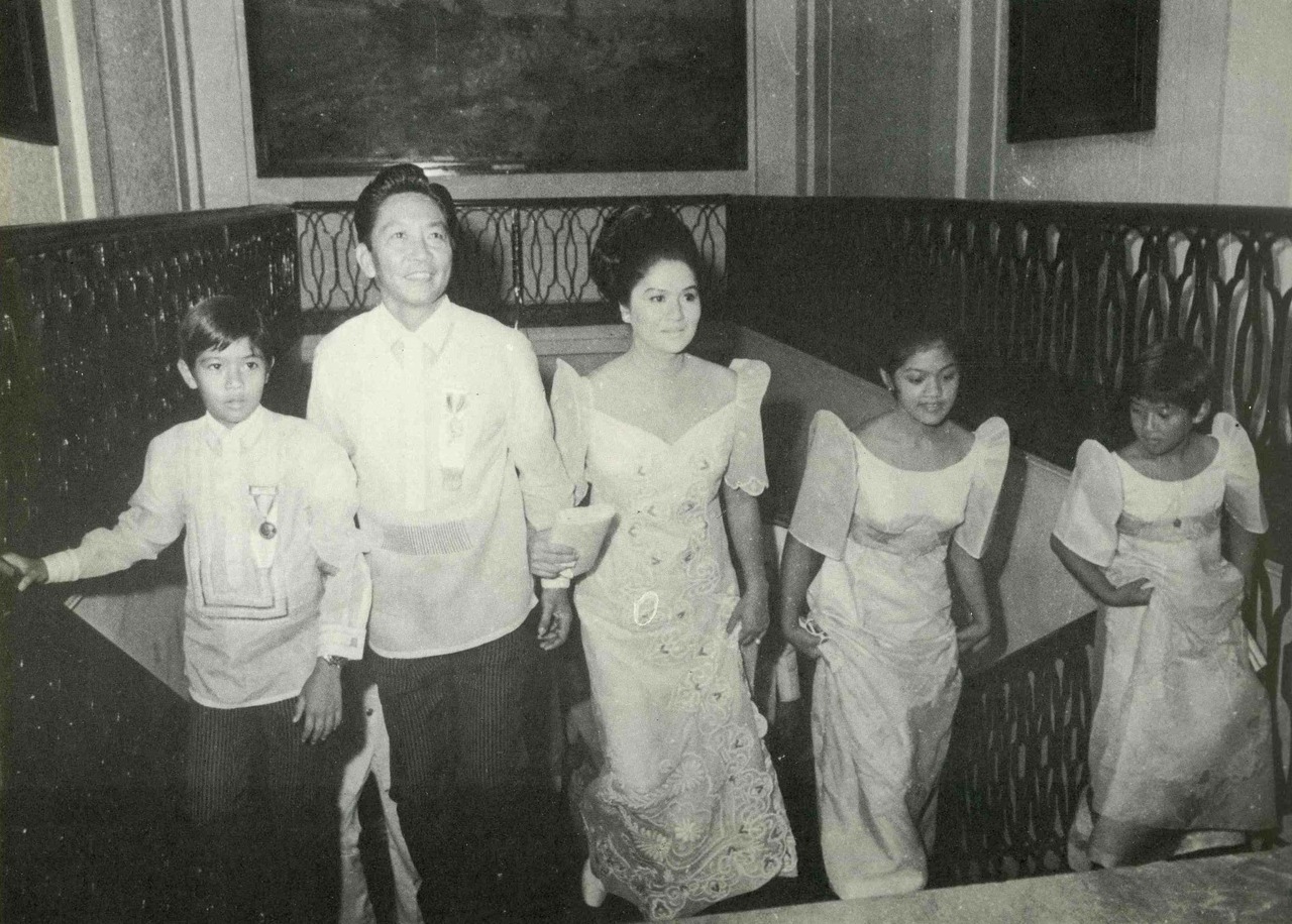 The Marcos family walking up a staircase